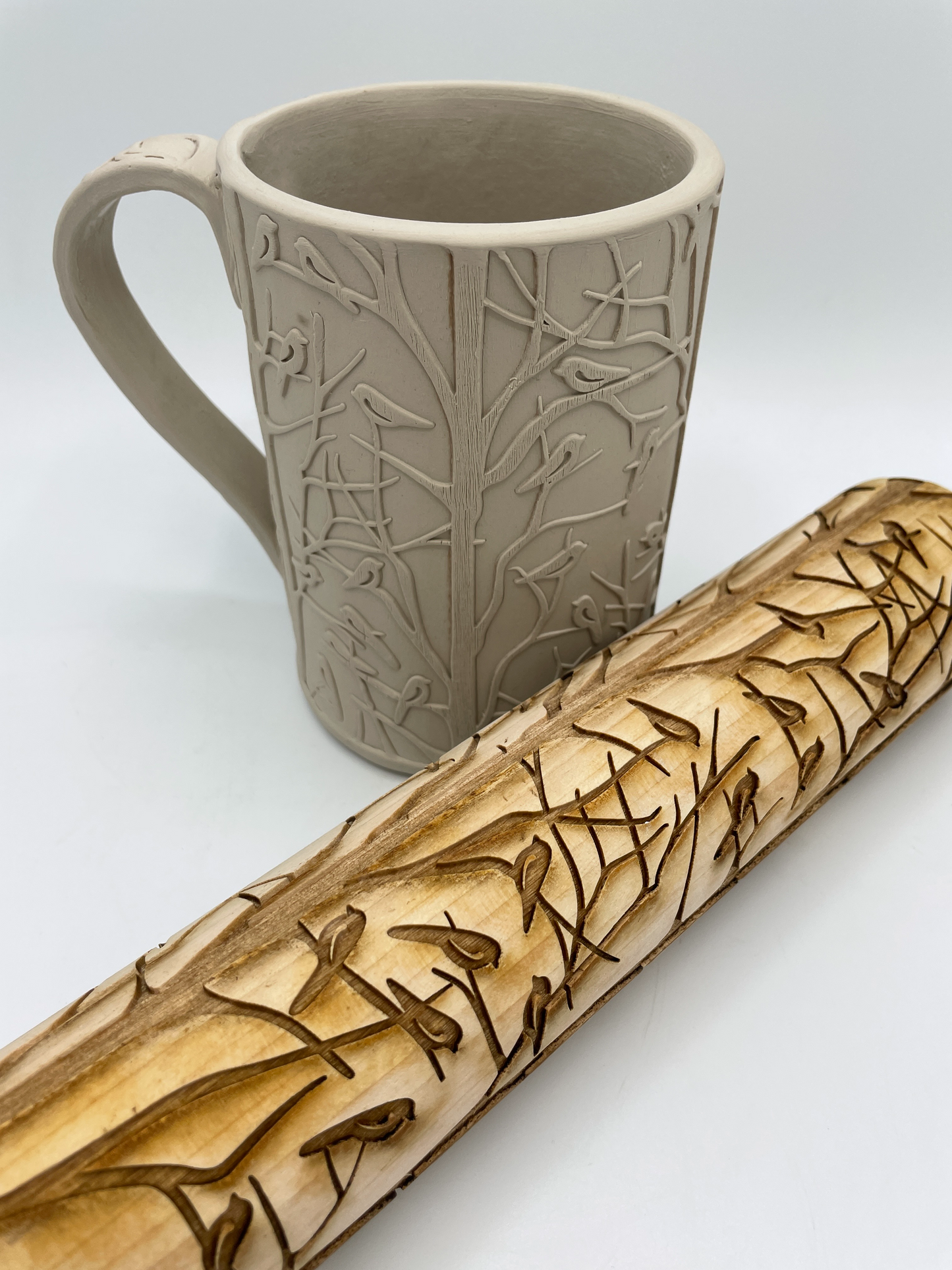 a contemporary designed of vertical tree trunks and beaches with many small birds resting on the branches. A clean forest design.